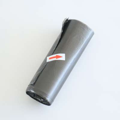 Black plastic garbage packing bag in roll